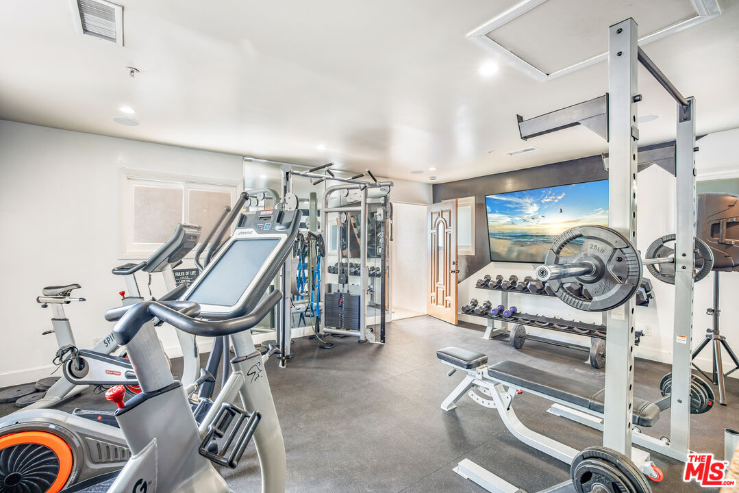 607 North Hillcrest Road Beverly Hills, CA 90210 - Photo 14 of 16 a view of a room with gym equipment