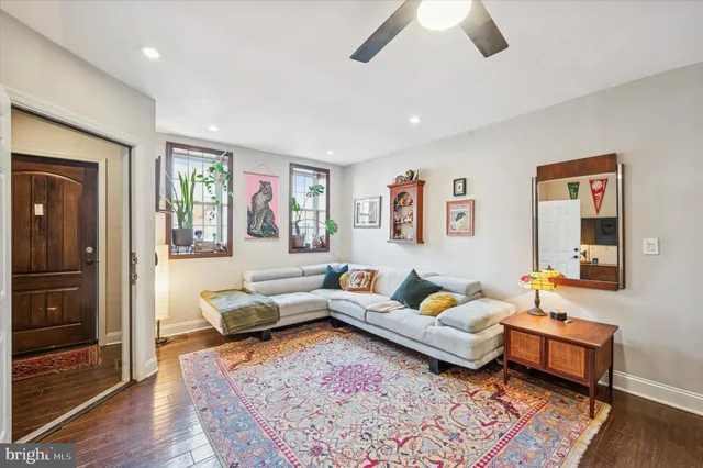 a living room with furniture and wooden floor