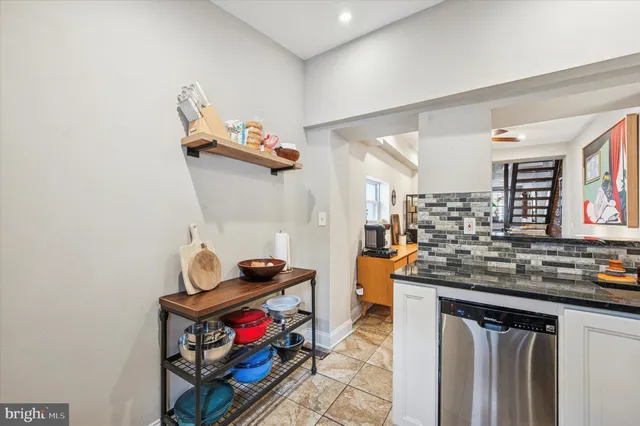 a kitchen with stainless steel appliances granite countertop a sink and cabinets