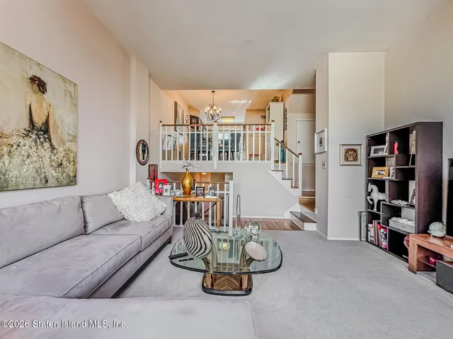 a living room with furniture and a book shelf