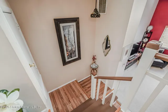 a view of entryway with furniture and wooden floor