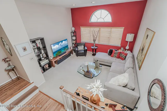 a living room with furniture a rug and a flat screen tv