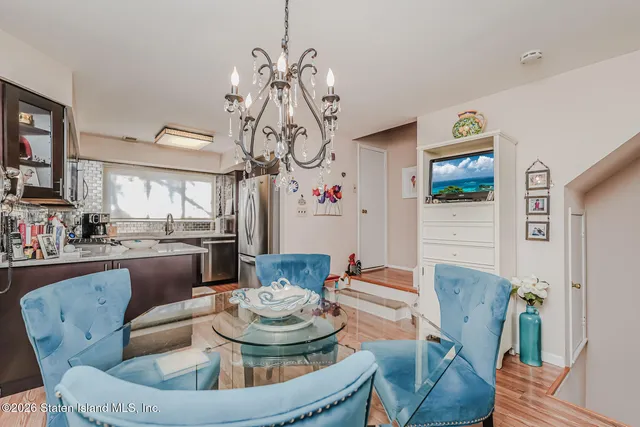 a living room with furniture and a dining room