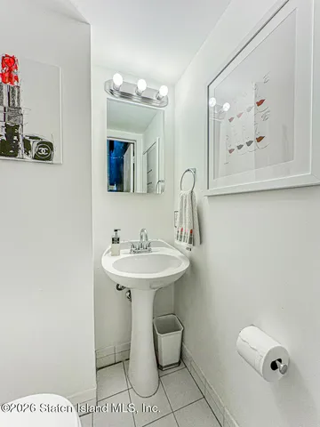 a bathroom with a sink a toilet and mirror