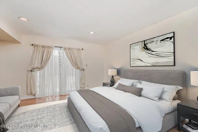 a bedroom with a bed and a couch