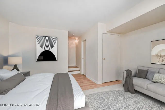 a bedroom with a bed and a couch