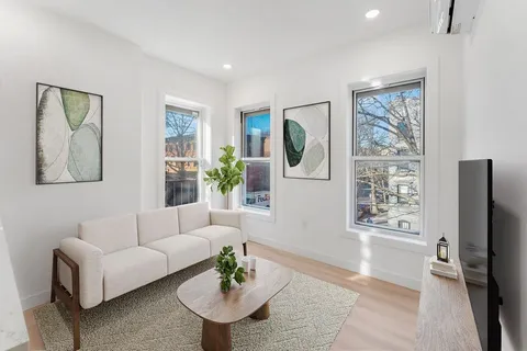 a living room with furniture a table and a flat screen tv