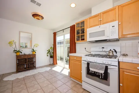 a kitchen with granite countertop a sink and a stove top oven