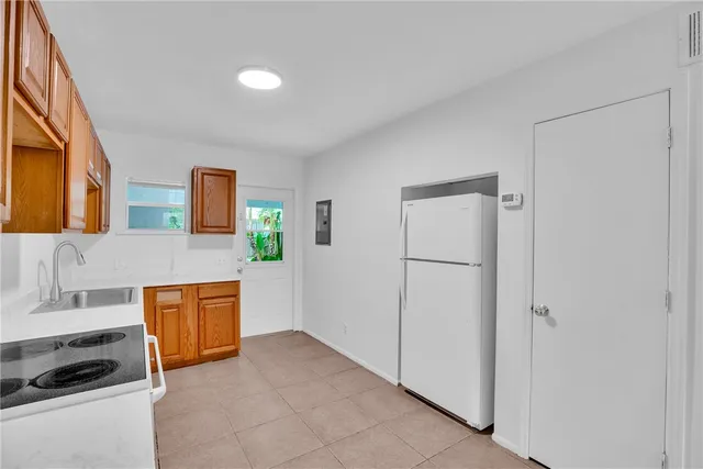 a view of kitchen with stainless steel appliances granite countertop a refrigerator and a sink