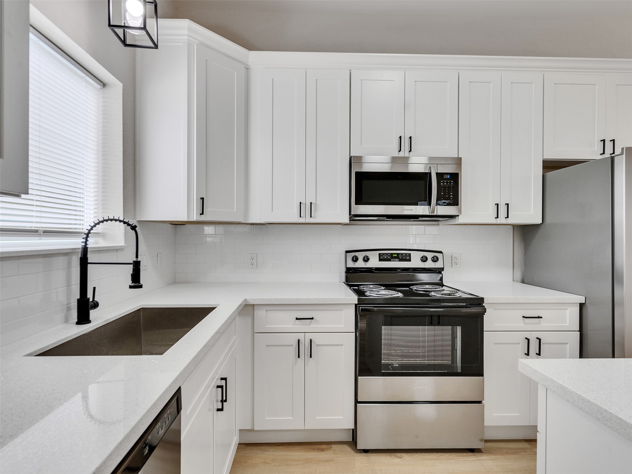 9707 Cargill Street, Unit AB Houston, TX 77029 - Photo 15 of 32 a kitchen with white cabinets and white appliances