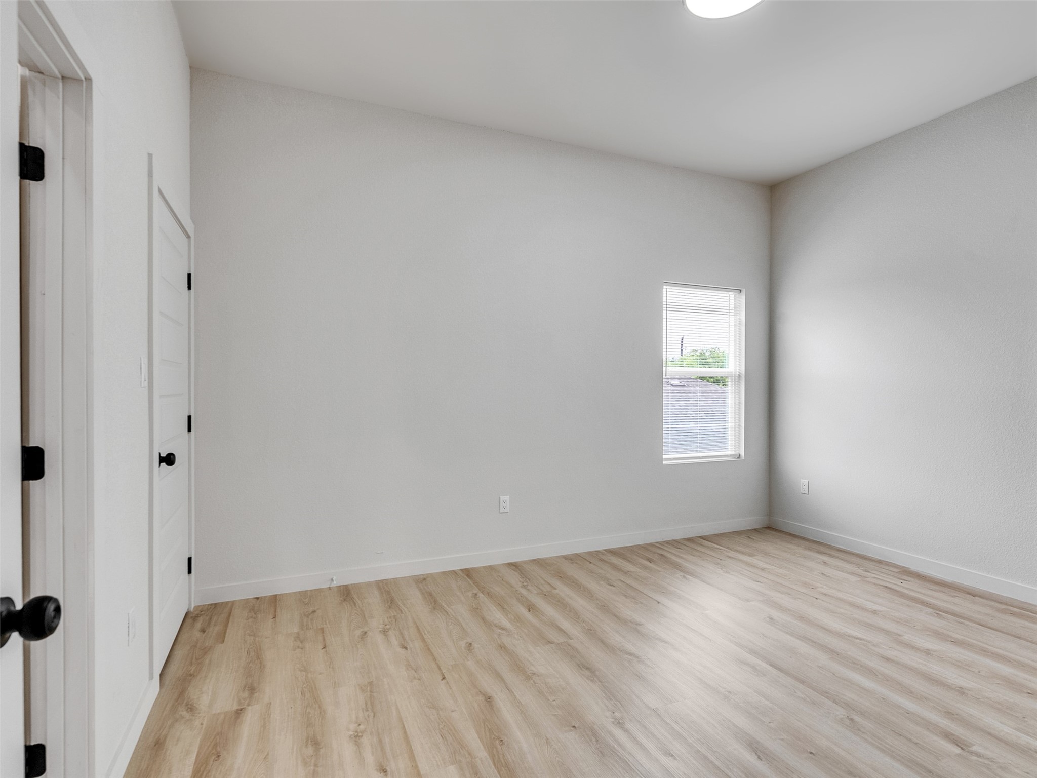 9707 Cargill Street, Unit AB Houston, TX 77029 - Photo 24 of 32 an empty room with wooden floor and windows