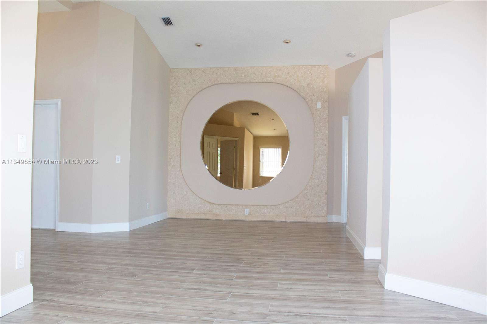 13221 Southwest 53rd Street Miramar, FL 33027 - Photo 11 of 32 a view of a livingroom with wooden floor and a window