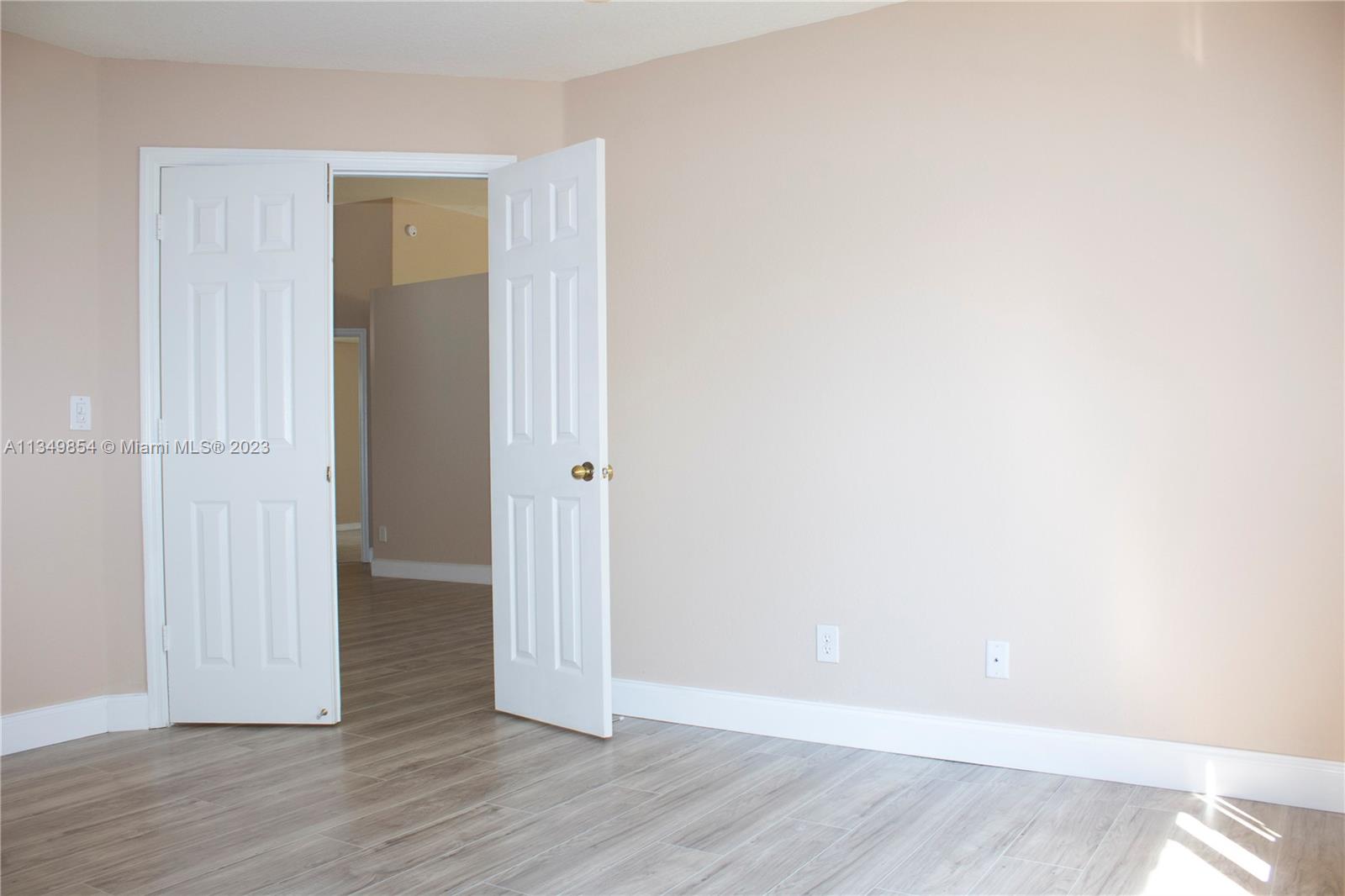13221 Southwest 53rd Street Miramar, FL 33027 - Photo 12 of 32 a view of an empty room with wooden floor