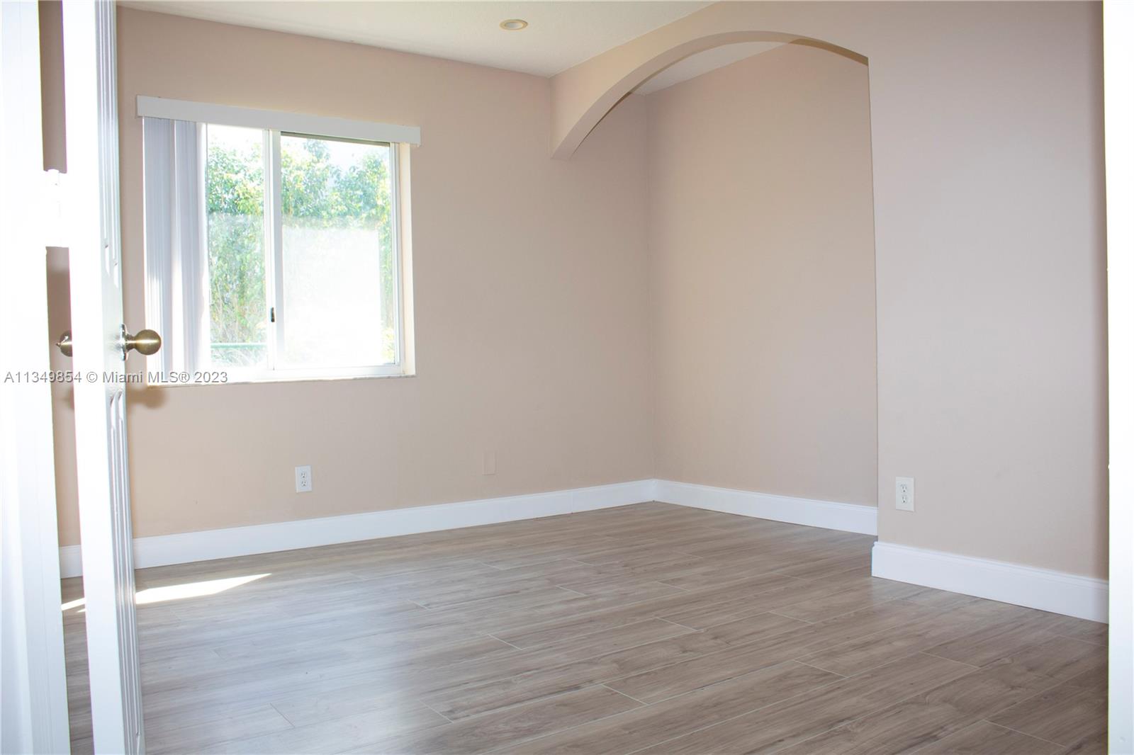 13221 Southwest 53rd Street Miramar, FL 33027 - Photo 13 of 32 an empty room with wooden floor and windows