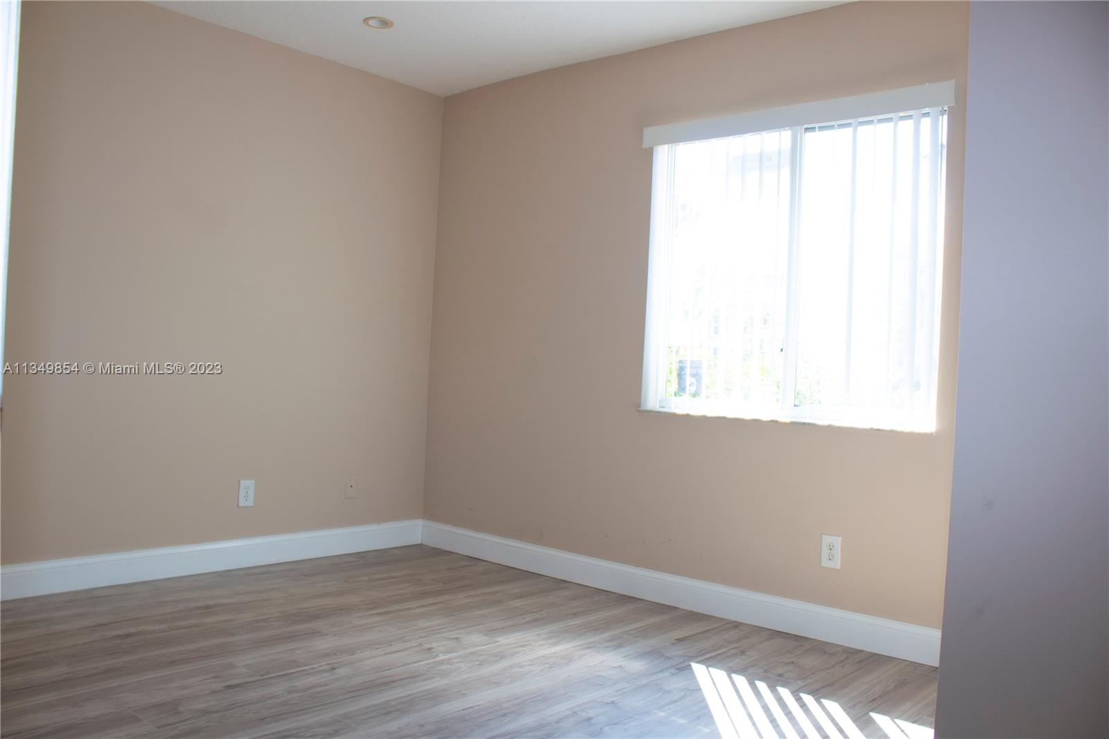 13221 Southwest 53rd Street Miramar, FL 33027 - Photo 14 of 32 a view of an empty room with wooden floor and a window