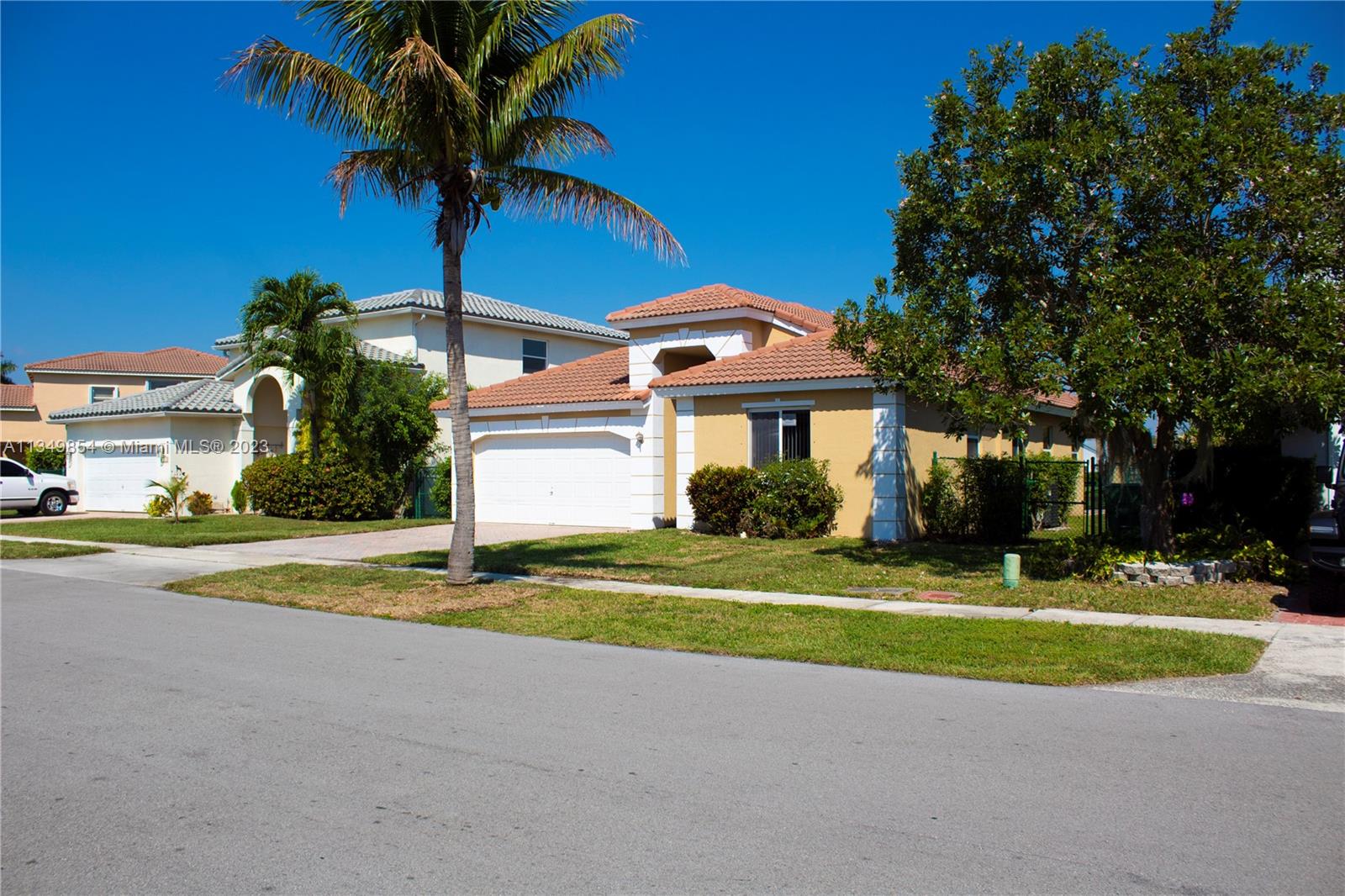 13221 Southwest 53rd Street Miramar, FL 33027 - Photo 2 of 32 a front view of a house with a yard and garage