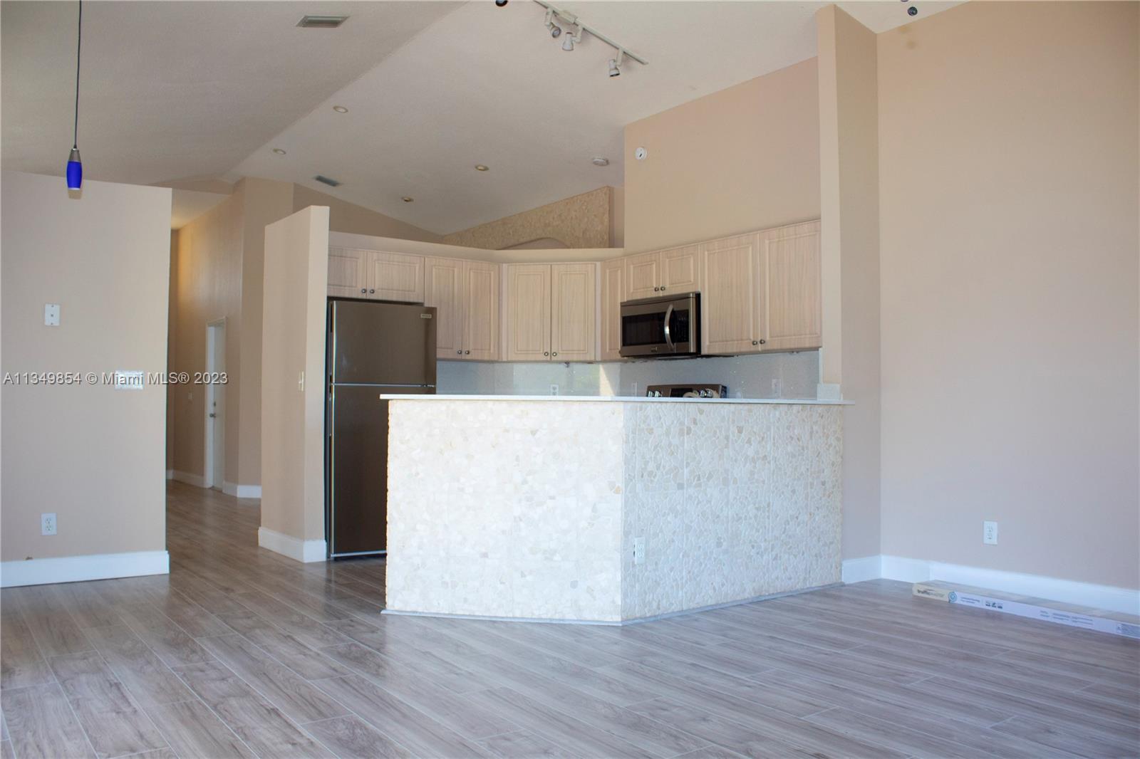 13221 Southwest 53rd Street Miramar, FL 33027 - Photo 25 of 32 a view of kitchen with stainless steel appliances a refrigerator and a microwave