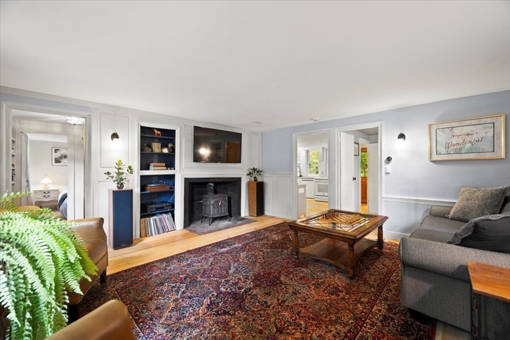 217 County Road Bourne, MA 02532 - Photo 11 of 30 a living room with furniture a fireplace and a flat screen tv