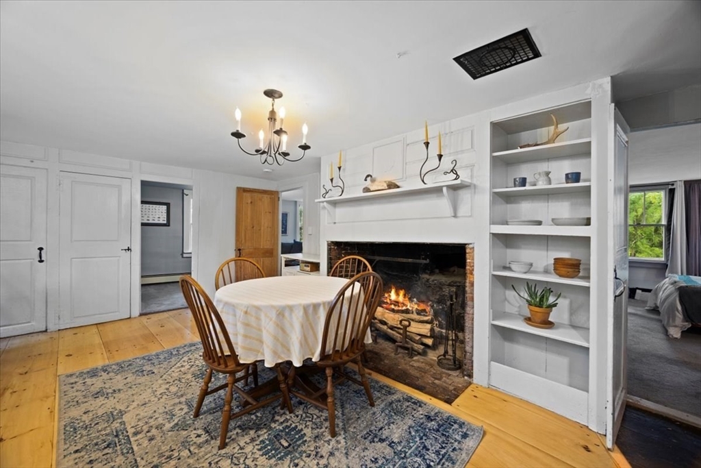 217 County Road Bourne, MA 02532 - Photo 6 of 30 a dining room with furniture and a fireplace