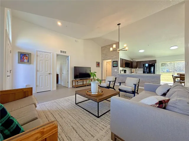 a kitchen with stainless steel appliances granite countertop a stove top oven and cabinets