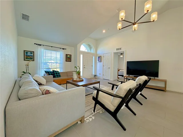 a spacious bedroom with a bed and ceiling fan