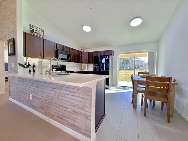 a spacious bedroom with a bed and a chandelier