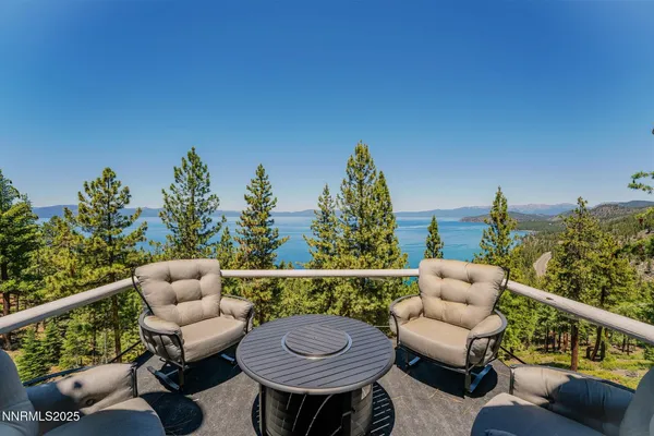a living room with furniture large window and wooden floor