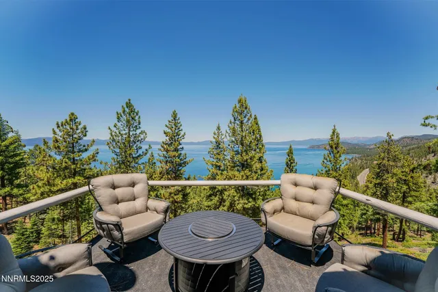 a living room with furniture large window and wooden floor