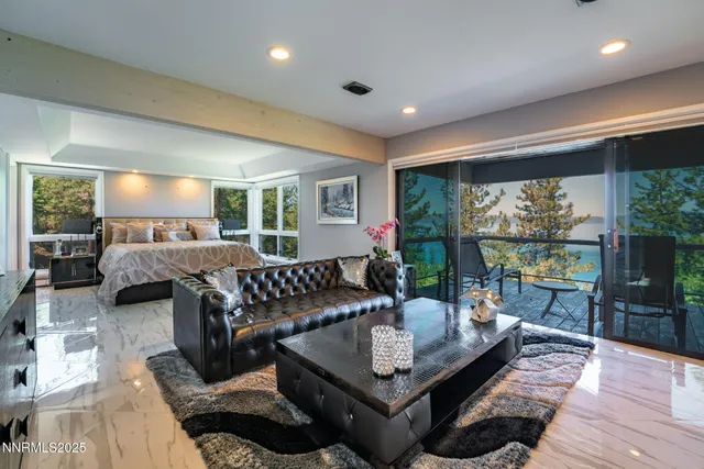 a bed room with a bed a television and a large window