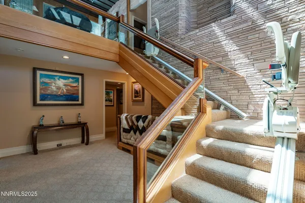a view of a kitchen with a sink stainless steel appliances cabinets and a wooden floor