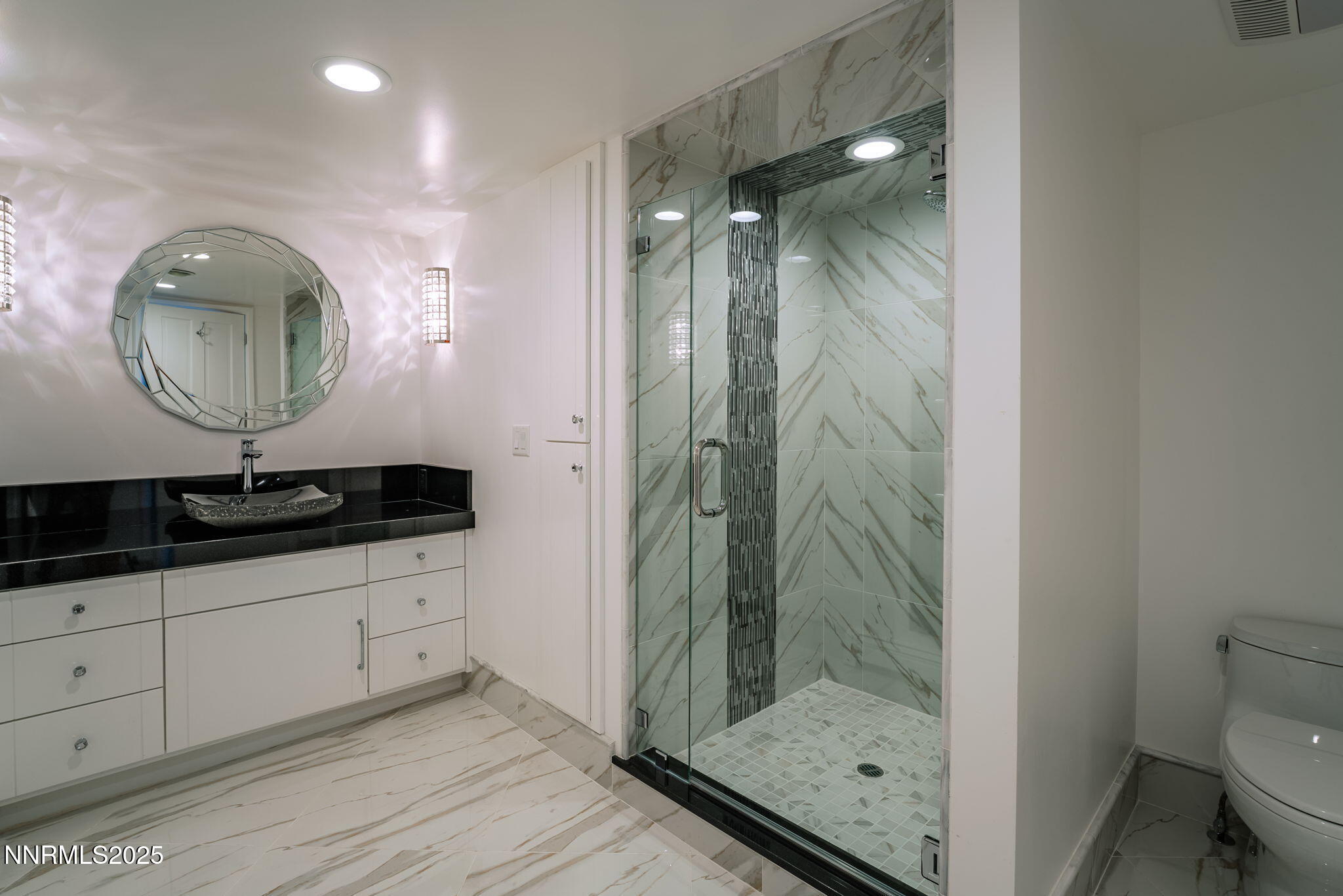 275 Chukkar Drive Glenbrook, NV 89413 - Photo 21 of 29 a bathroom with a shower a mirror and a sink