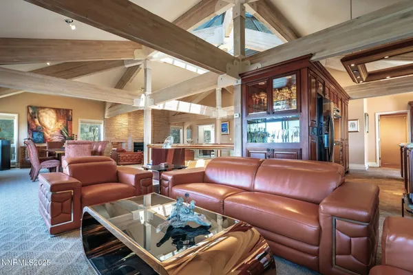 a living room with furniture a ceiling fan and a window