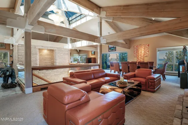 a living room with furniture a ceiling fan and a window