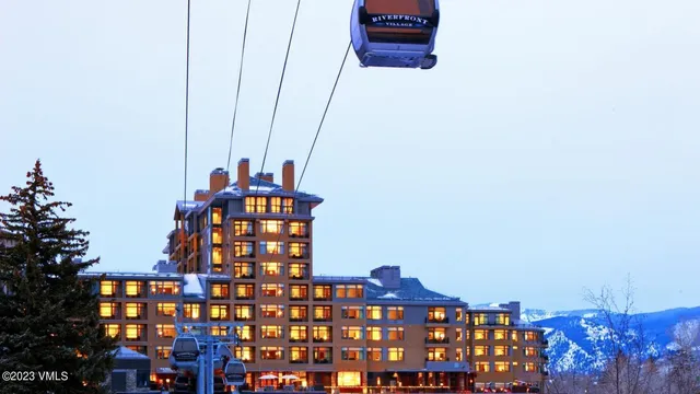 a living room with furniture a lamp and a chandelier