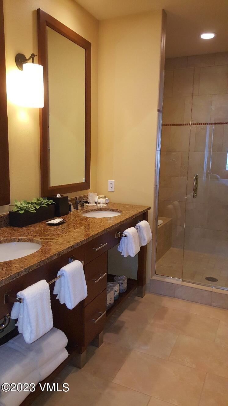 218 Riverfront Lane, Unit 2407A/2407B Avon, CO 81620 - Photo 20 of 22 a bathroom with a tub sink and mirror