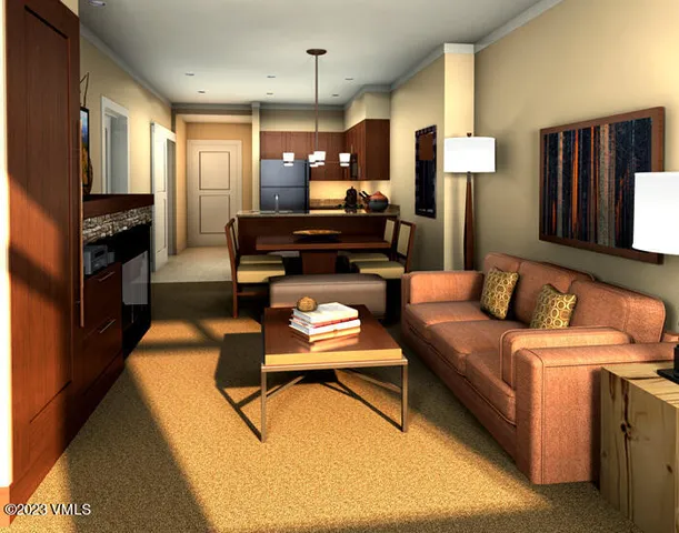 a living room with furniture and a kitchen view