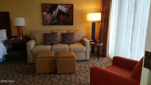 a living room with furniture and a lamp