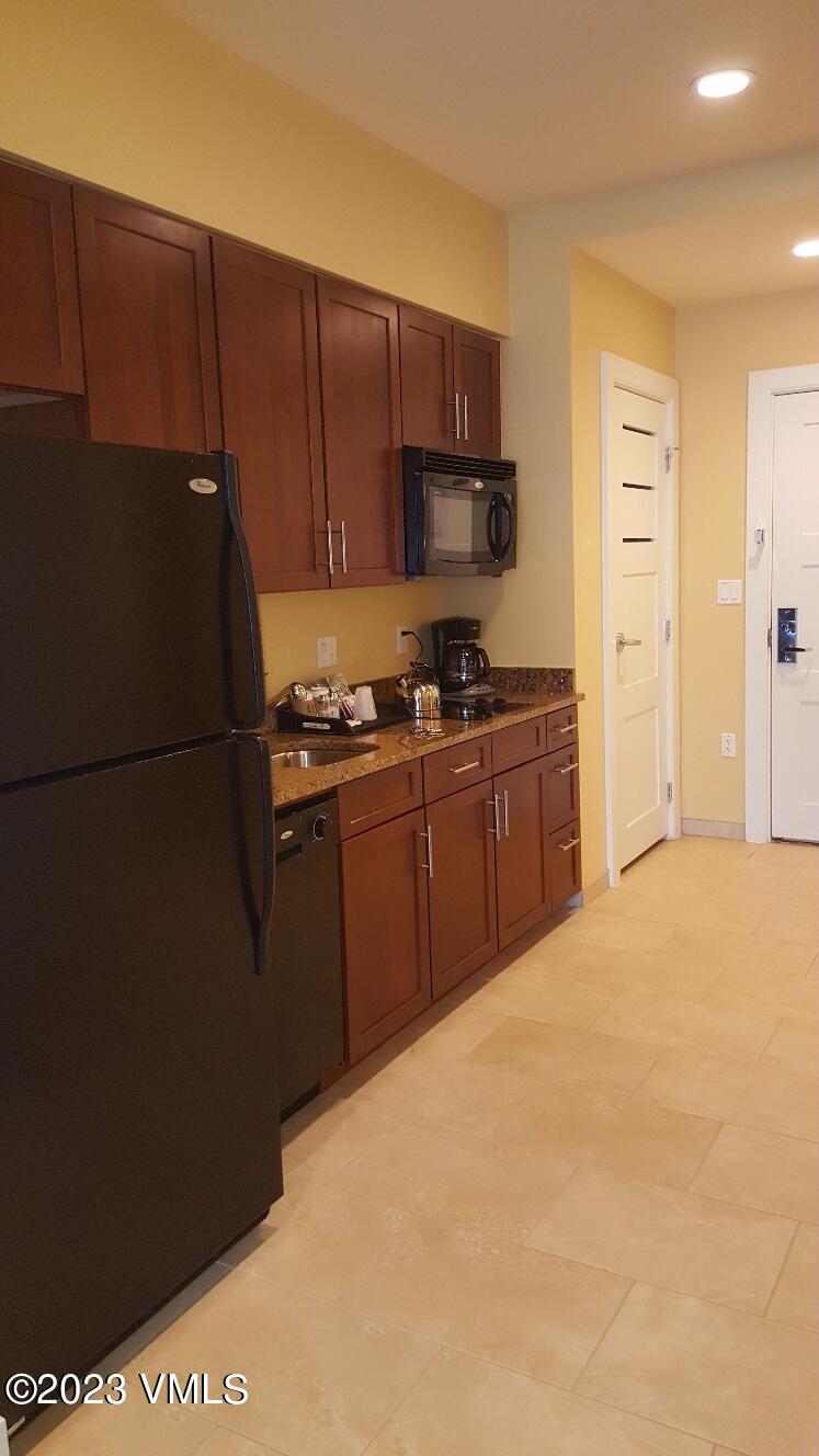 218 Riverfront Lane, Unit 2407A/2407B Avon, CO 81620 - Photo 8 of 22 a kitchen with stainless steel appliances granite countertop a refrigerator a stove a sink and a microwave