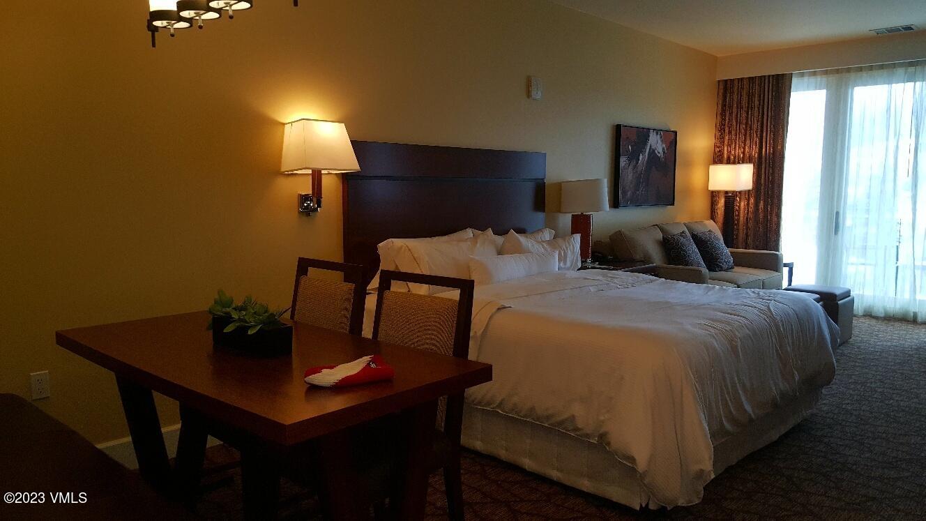 218 Riverfront Lane, Unit 2407A/2407B Avon, CO 81620 - Photo 9 of 22 a bedroom with a bed and a table
