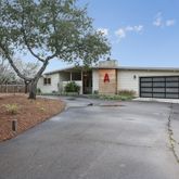a view of a house with a yard and garage
