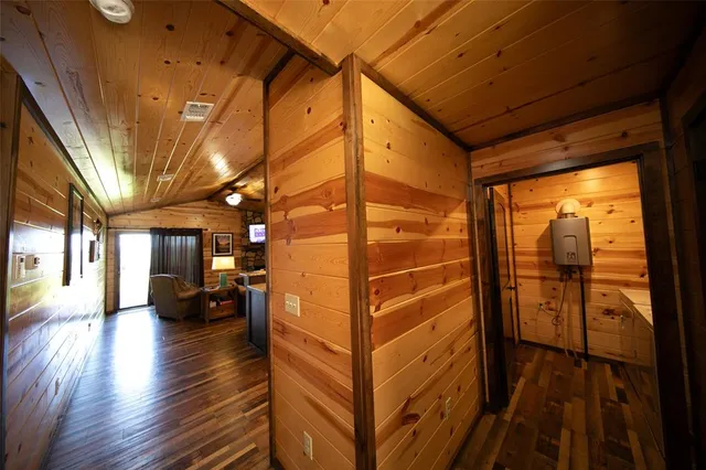 a view of a porch with wooden floor and furniture