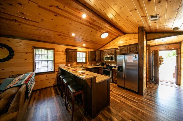 a kitchen with granite countertop lots of counter top space and stainless steel appliances