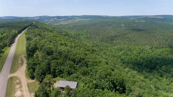a view of a lush green hillside and houses
