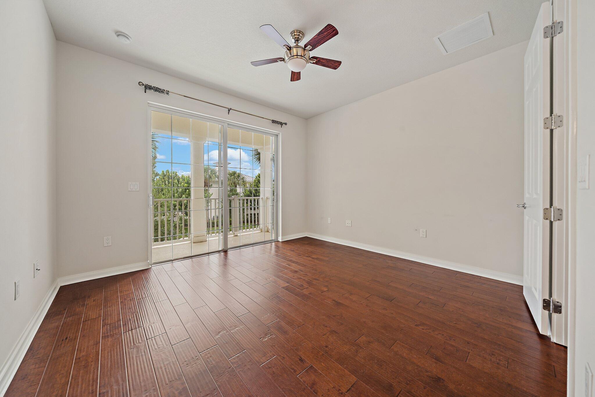 3253 Duncombe Drive Jupiter, FL 33458 - Photo 14 of 33 an empty room with wooden floor and windows