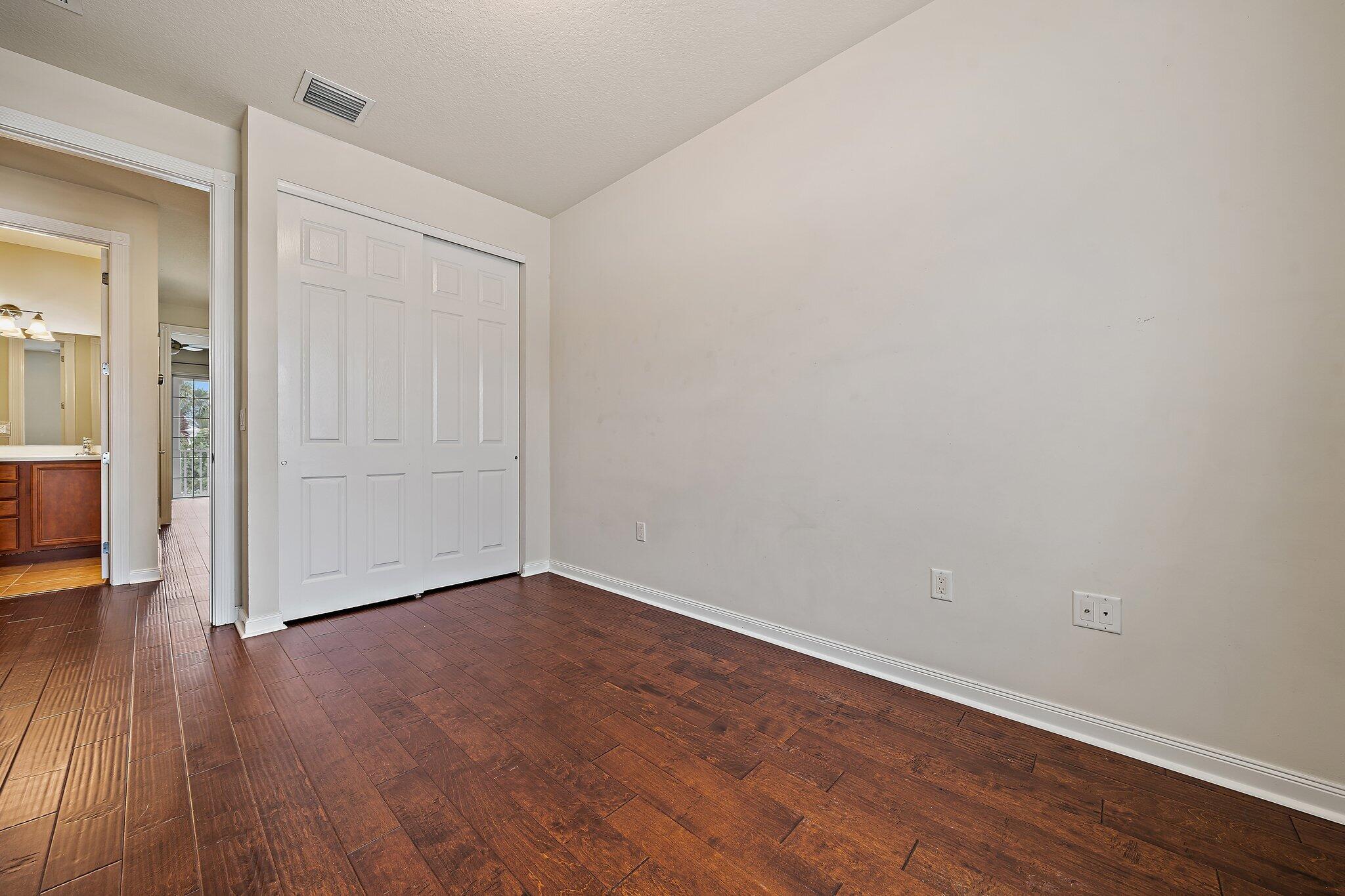 3253 Duncombe Drive Jupiter, FL 33458 - Photo 15 of 33 a view of an empty room with wooden floor