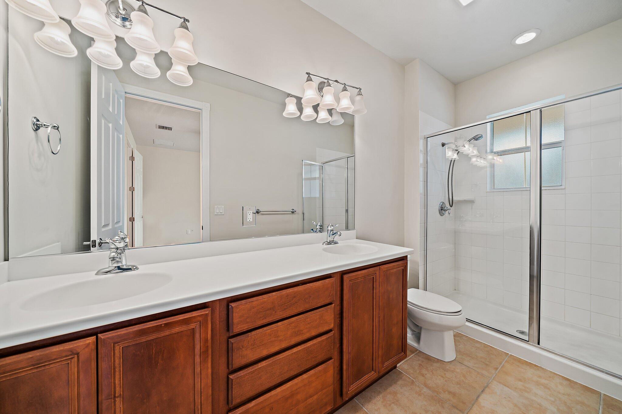 3253 Duncombe Drive Jupiter, FL 33458 - Photo 16 of 33 a bathroom with a sink a toilet and shower