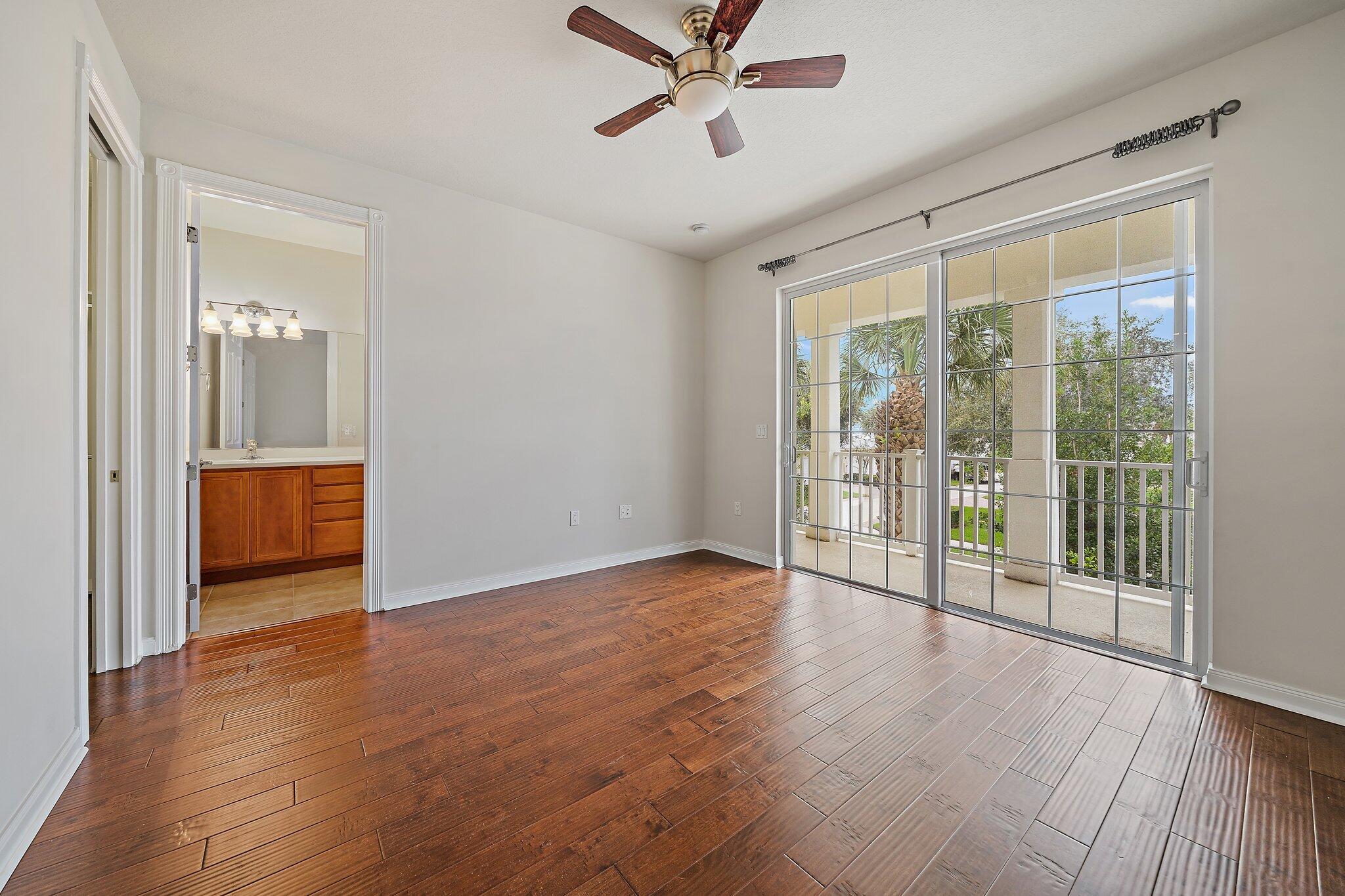 3253 Duncombe Drive Jupiter, FL 33458 - Photo 18 of 33 wooden floor in an empty room with a window
