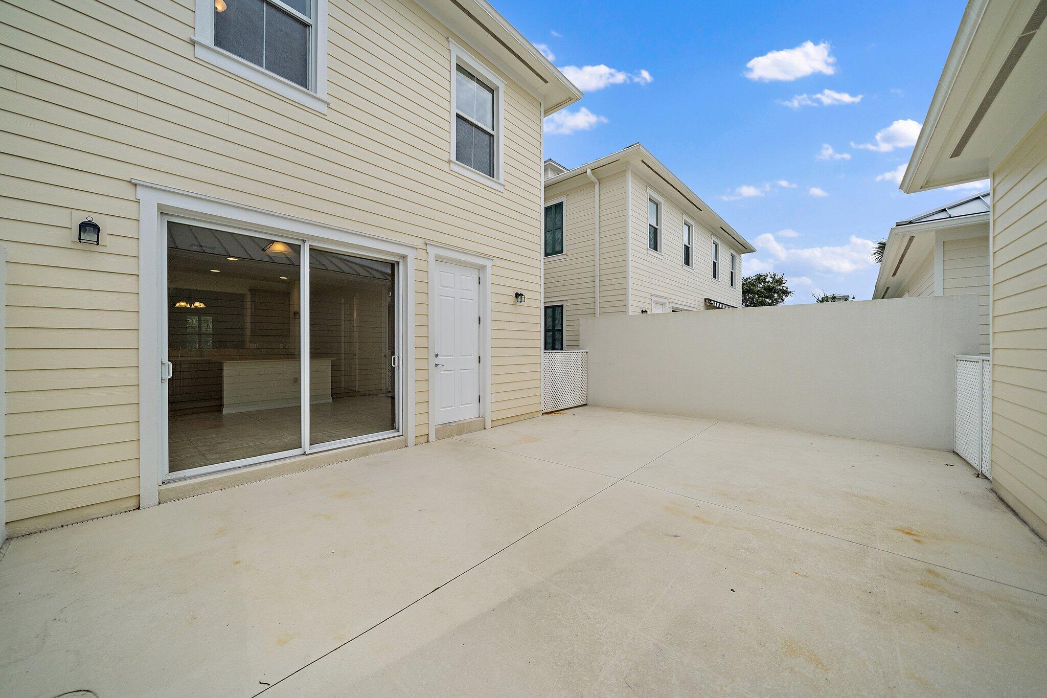 3253 Duncombe Drive Jupiter, FL 33458 - Photo 25 of 33 a view of a white house with a outdoor space