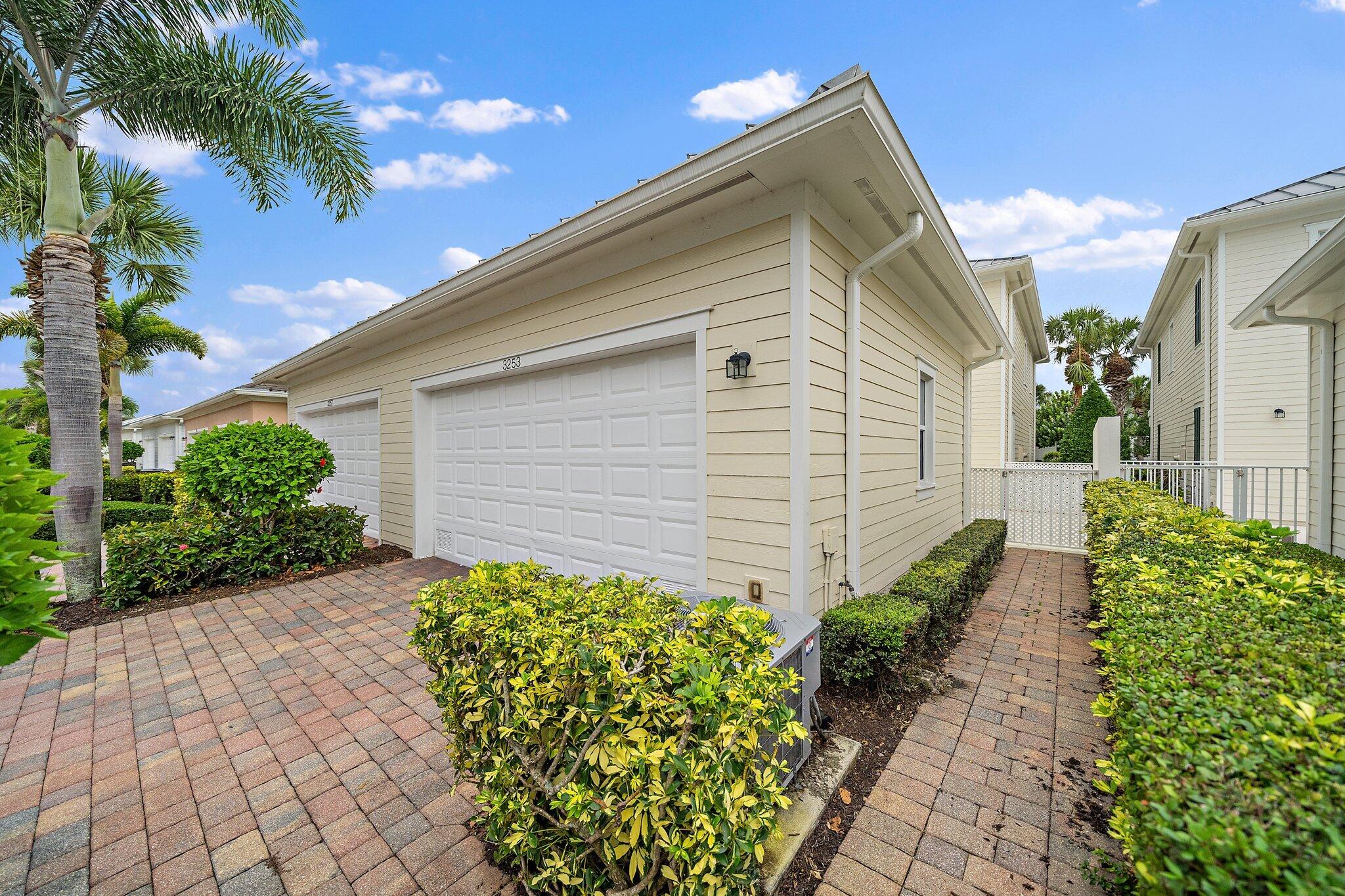 3253 Duncombe Drive Jupiter, FL 33458 - Photo 27 of 33 a front view of a house with garden