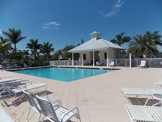 3253 Duncombe Drive Jupiter, FL 33458 - Photo 30 of 33 a view of a house with swimming pool and sitting area